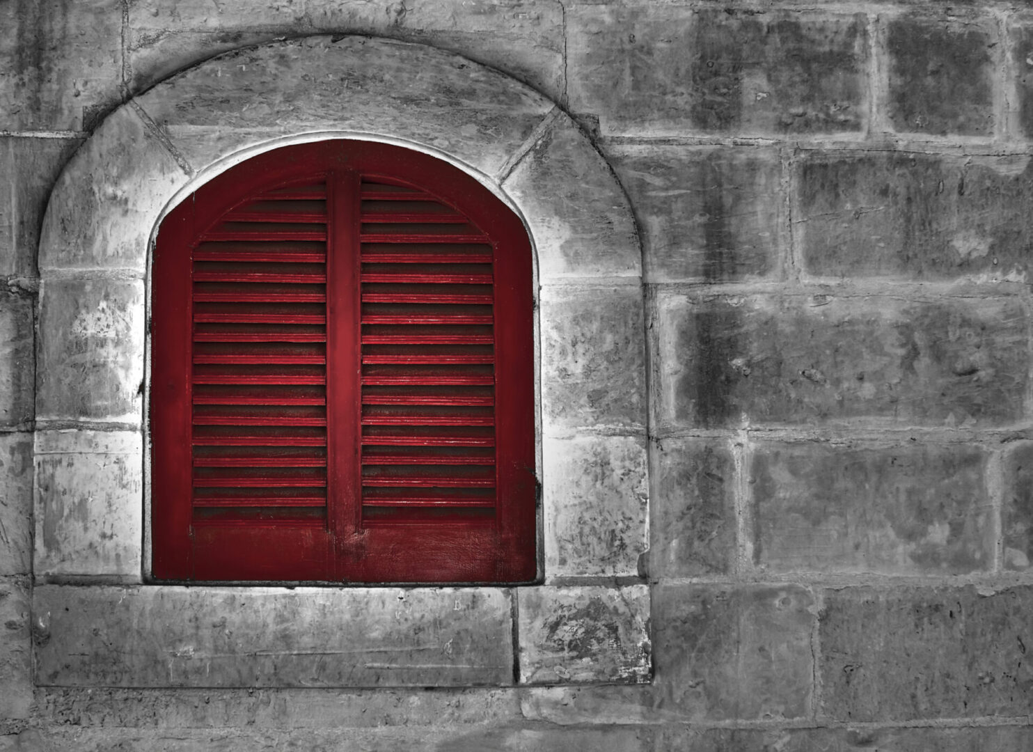 A red window on a concrete wall