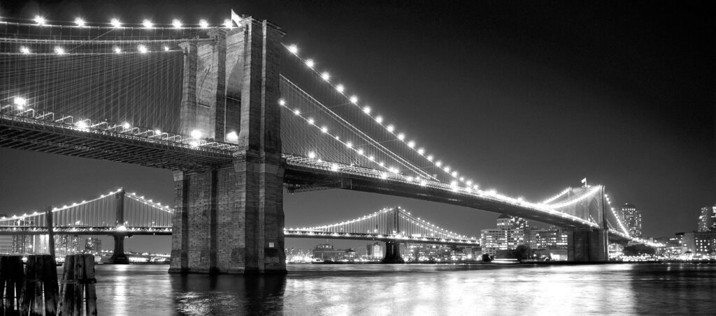 A black and white photo of two bridges